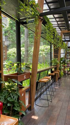 the inside of a restaurant with tables and plants