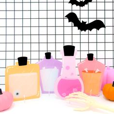 various bottles and utensils sitting on a table with halloween decorations in the background