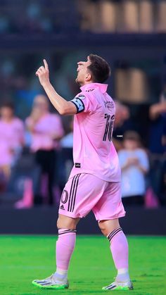 a soccer player is looking up at the sky while holding his hands in the air