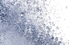 water bubbles are seen in the air on a white background