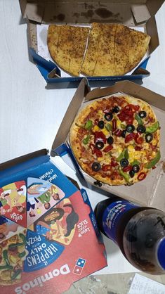 two pizzas in boxes, one with cheese and the other with toppings on it