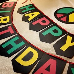 happy birthday banner made out of black and yellow paper with the words happy birthday on it