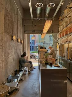 two people sitting at a counter in a restaurant