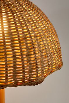 a wicker lamp is lit up with the light on