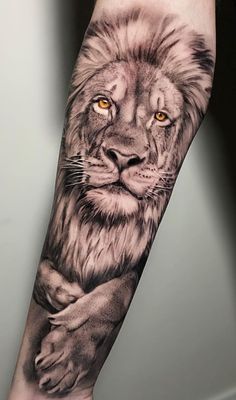 a man's arm with a lion tattoo on it