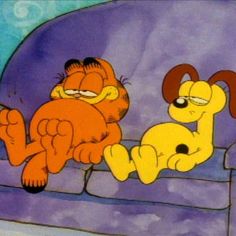 the cartoon dog and cat are laying on a couch