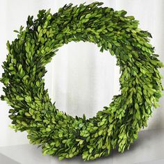 a green wreath sitting on top of a table