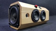 a wooden speaker sitting on top of a table