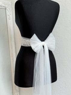 A stunning, elegant statement wedding sash is exquisitely beaded in beautiful vintage pattern. Your choice tulle  sash is attached to the beading and ties at the back into a bow.  An ultimate luxurious accent piece for your wedding dress or for any special occasion dresses. Accentuate your waist and add a touch of feminine charm to any dress with this tulle sash. Even the most simple gown can transform into a dreamy ensemble with this voluminous bow. Color embroidery - ivory or white Color tulle may be different  - white, ivory... and other Bead embroidery length 50 cm The belt is made as a long ribbon that you can tie around your waist. Elegant Tulle Bridal Accessories For Bride, Elegant Bridal Accessories In Tulle, Elegant White Bride Sashes, Elegant Tulle Veil For Bridal Shower, Elegant Organza Bridal Accessories For Ceremony, Elegant Tulle Bridal Accessories, Elegant Bridal Sashes For Bride, Elegant Bridal Sashes, Elegant White Tulle Fabric For Bride