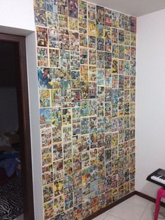 a wall covered in comic books with a keyboard on the floor and a chair next to it