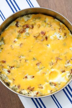 a casserole dish with cheese and other toppings in a pan on a table