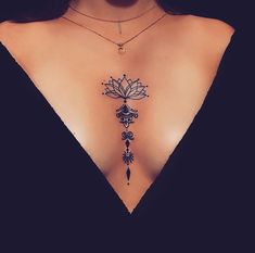 a woman's chest with a tattoo design on the top and bottom part of her body