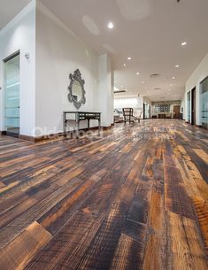 an empty room with wooden floors and white walls