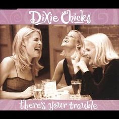 three women sitting at a table laughing and having drinks together with the caption, dixie checks there's your trouble