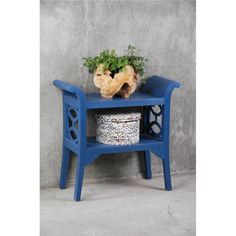 a blue bench with a potted plant on it and a basket under the seat