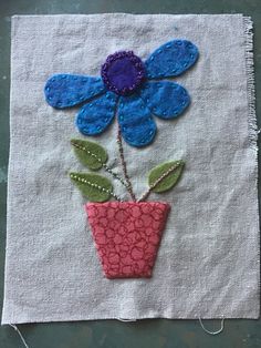 a flower in a pot on a piece of cloth