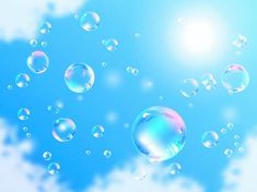 soap bubbles floating in the air on a sunny day