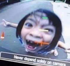 a young child is smiling and holding an orange object in front of her face with the caption never respond solely on camera