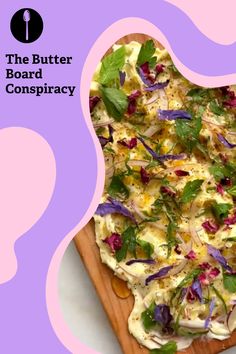 a wooden cutting board topped with a pizza covered in toppings