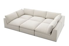 a white couch sitting on top of a white floor