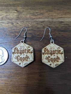 Chaotic Good dice earrings. These Chaotic Good earrings are made from 1/8 inch birch with the dice features and the alignment engraved into the top. The earrings are double sided so the natural movement of the earring won't matter for visibility of what is on them. The earrings are pictures next to a quarter and a penny for size reference. These earrings are perfect for the gamer geek or 80s show buff who are in love with paper and dice games such as DnD. They are super lightweight so they are c True Neutral, Chaotic Good, 80s Shows, Dice Earrings, Neutral Earrings, Earrings Wood, Natural Movement, Dnd Dice, Dice Games