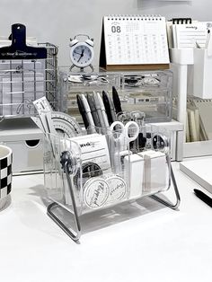 an office desk with clear acrylic drawers and various pens and pencils on it