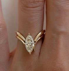 a woman's hand with a ring on it and a diamond in the middle