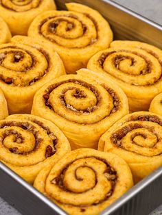 there are many cinnamon rolls in the pan