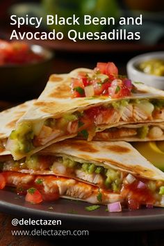 two quesadillas on a plate with salsa and guacamole in the background