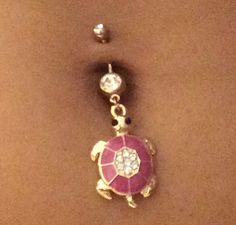 a pink and white turtle belly button ring