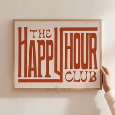 a person holding up a sign that says the happy hour club in red and white