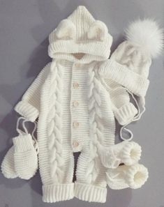 a white knitted sweater and matching hat