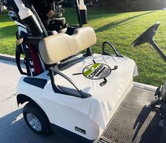 a white golf cart parked on the side of a road