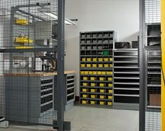 the storage room is filled with lots of yellow and black bins for various items