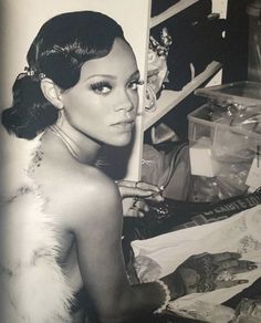 a black and white photo of a woman in front of a refrigerator