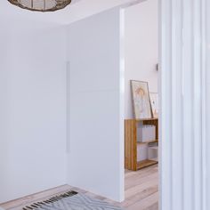 an empty room with white walls and wood flooring