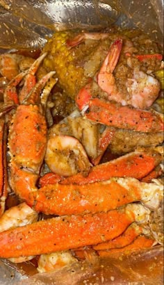 cooked lobsters and other seafood in a pan