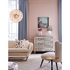 a living room with pink walls and furniture