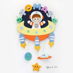 a child's wall clock with an astronaut on the front and stars in the back