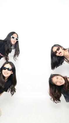 three women in sunglasses are posing for the camera