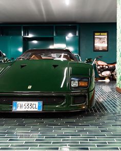 a green sports car parked in a garage