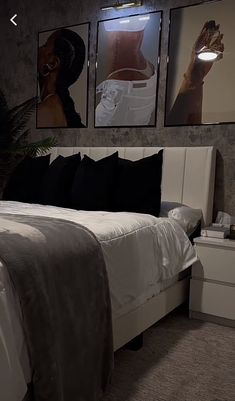 a large bed sitting in a bedroom next to two pictures on the wall above it