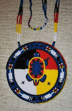 "Beaded Medallion Necklace with a turtle and 4 directions design. #10 Czech beads. 4-1/2\" in diameter. Leather back." Beaded Medallion Necklace, Beaded Medallion, 4 Directions, Beautiful Beadwork, Native American Beadwork, Fancy Beads, Turtle Design, Beadwork Patterns, Native American Beading