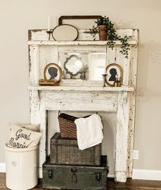 an old white fireplace mantel with some baskets and other items on top of it