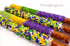 there are four different colored candy sticks with sprinkles