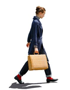 a woman walking with a wicker basket on her back