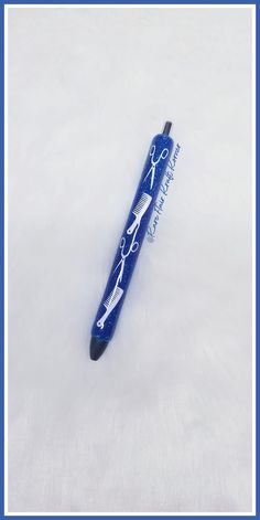 a blue pen with scissors on it sitting in the middle of some snow covered ground