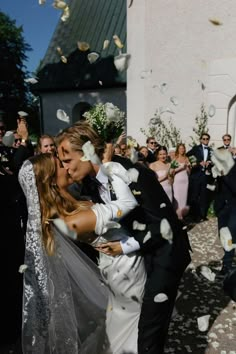 a bride and groom are surrounded by confetti