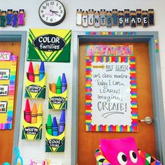 a classroom door decorated with colorful crayons and chalk markers on the front wall