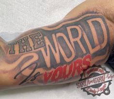 a man's arm with the words world is yours on it